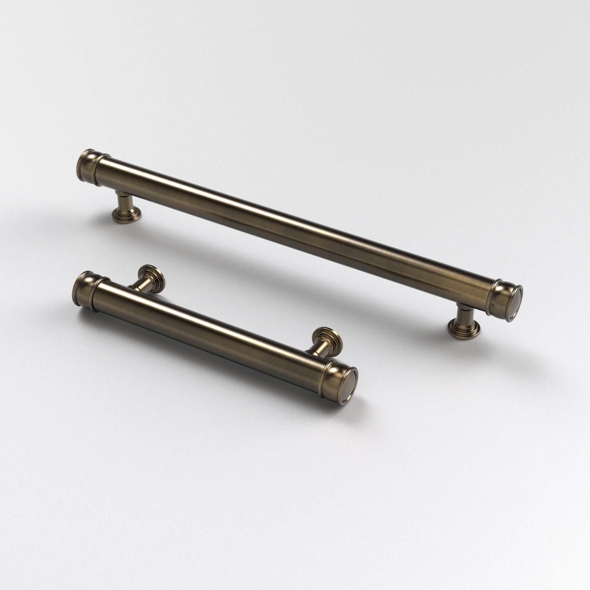 two antique brass-finished brass hexagon cabinet pulls. The Esher Cabinet Pull displayed here against a white background.