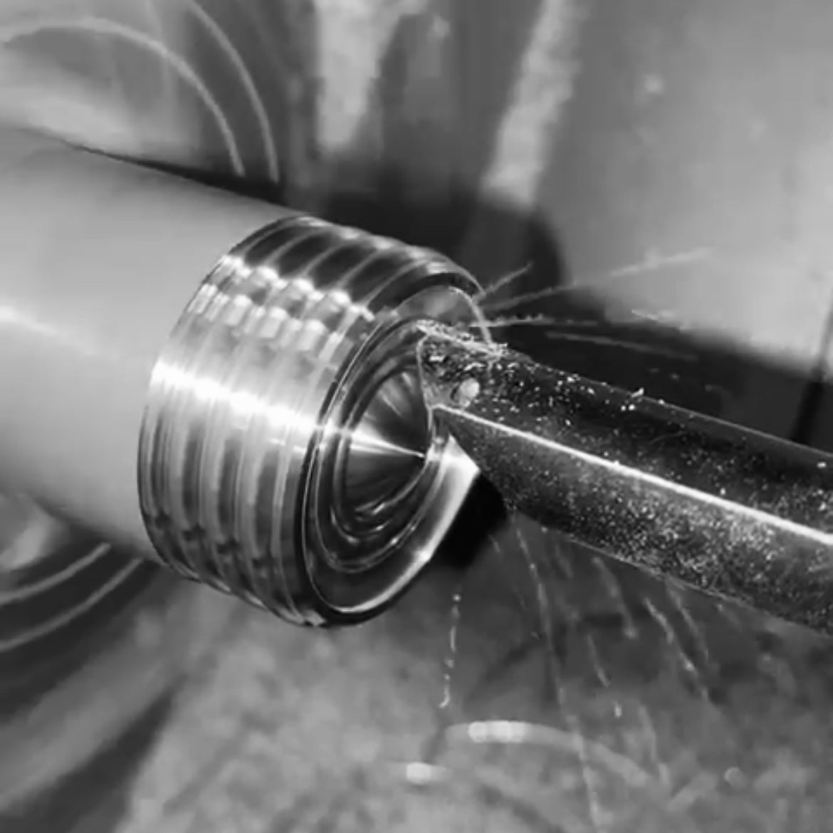 Close up black and white image of the 'Warwick' solid brass cabinet knob being manufactured on cnc lathe.